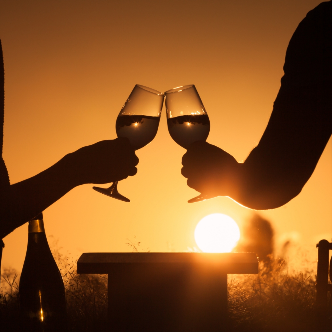 Two glasses of wine, toasting a beautiful sunset near Rutland, MA