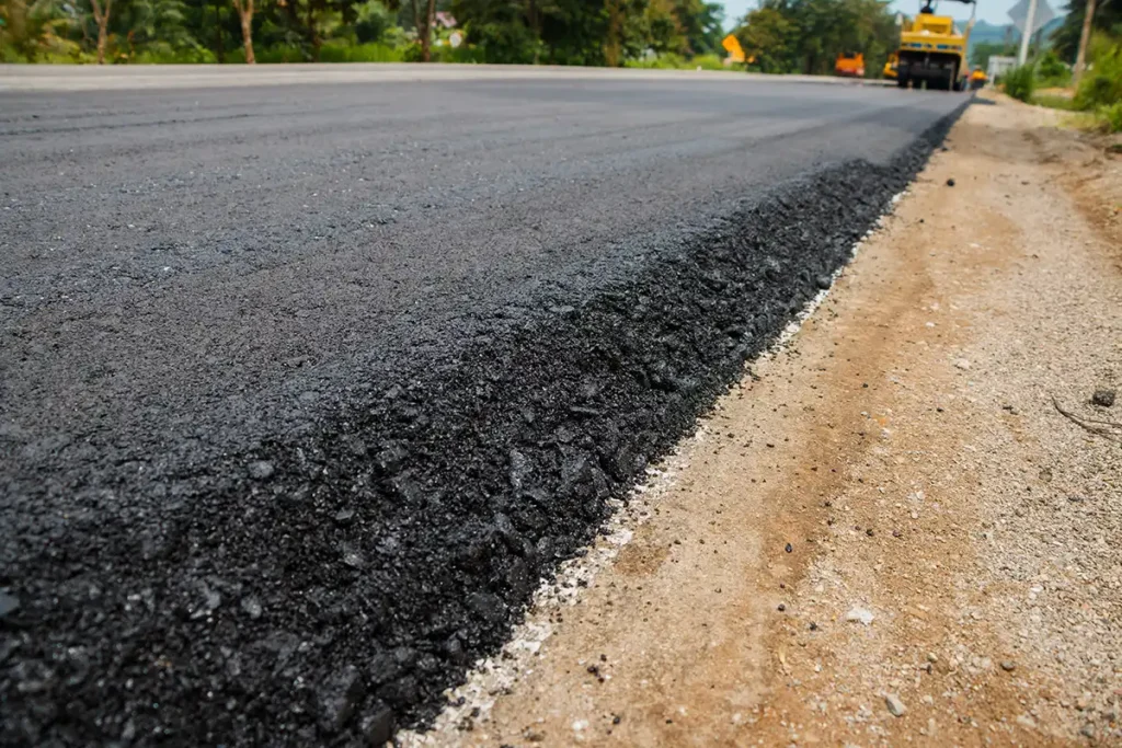 Close-up view of freshly paved asphalt road during new street construction at Harmony Place in Rutland, Massachusetts.